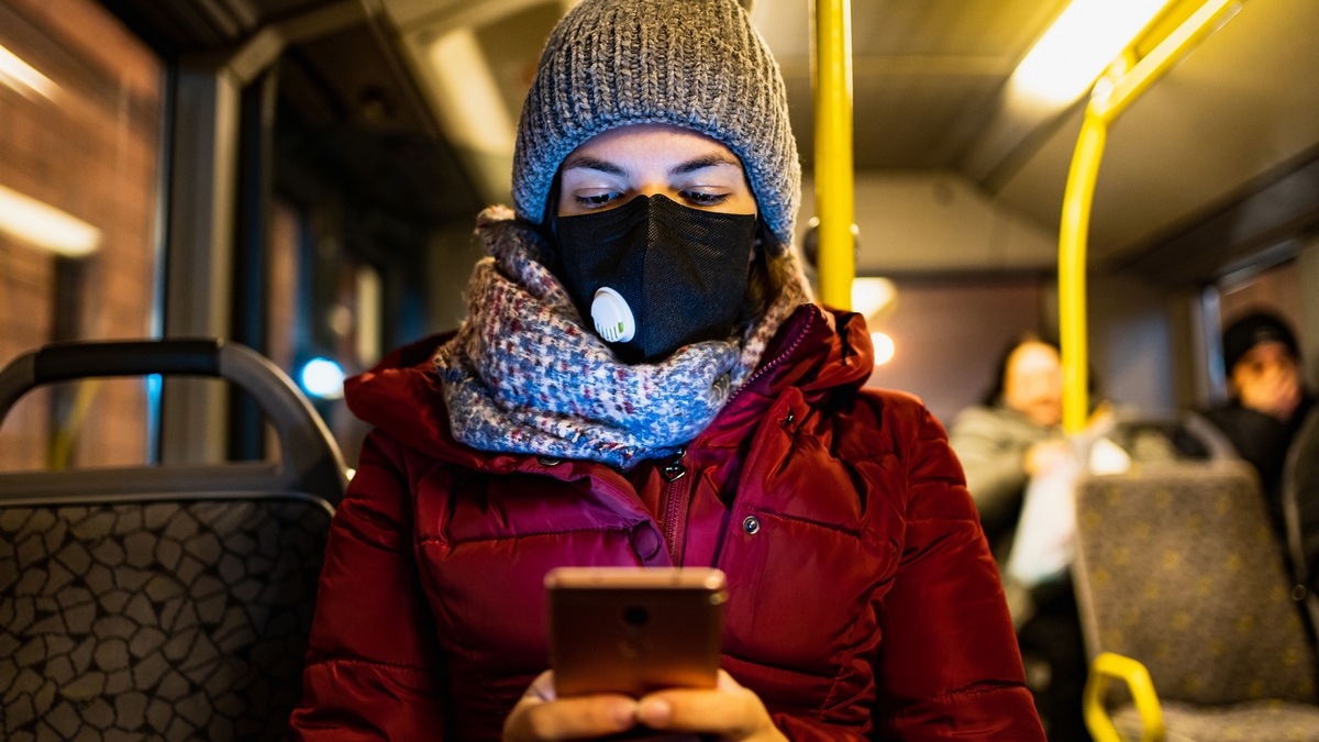 Woman in bus wearing n95 face mask