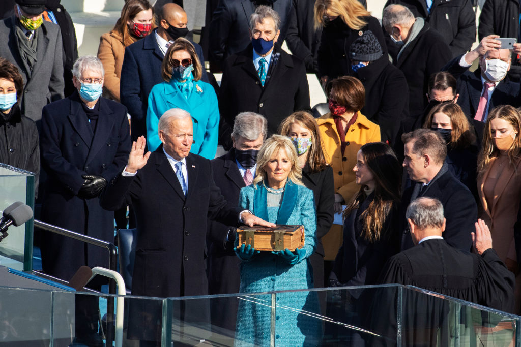 UNITED STATES - JANUARY 20: President Joe Biden is sworn in as the 46th President of the United States by Supreme Court Chief Justice John Roberts at the inauguration on the West Front of the U.S. Capitol on Wednesday, January 20, 2021. First lady Dr. Jill Biden, holds the bible.