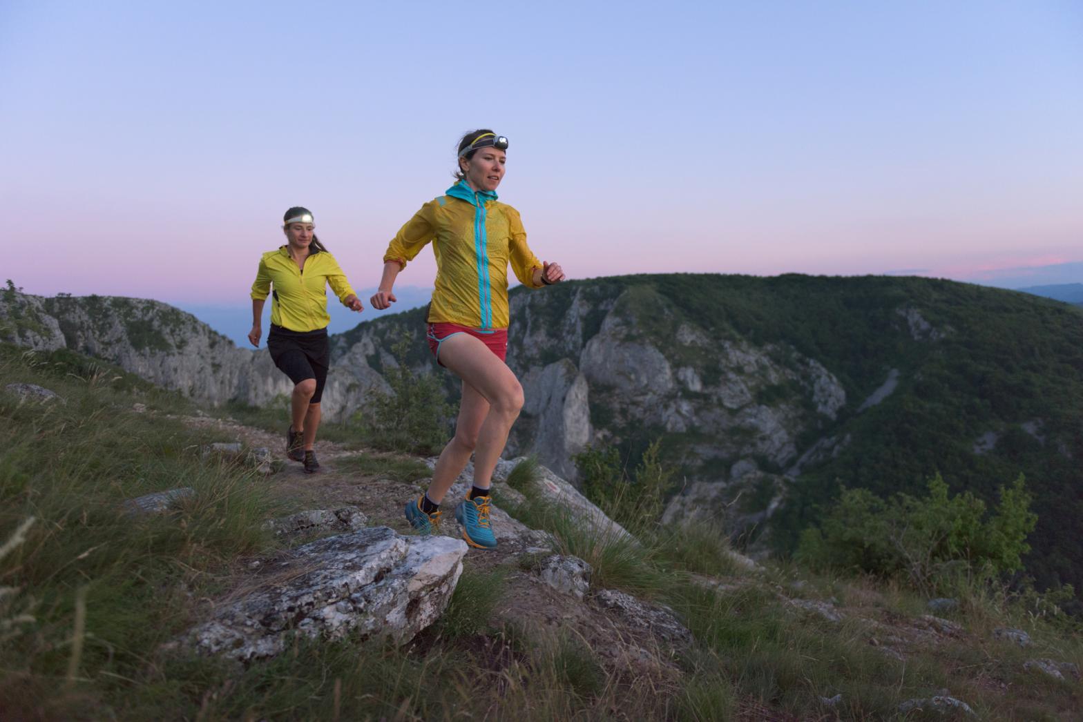 Two female runners with headlamps