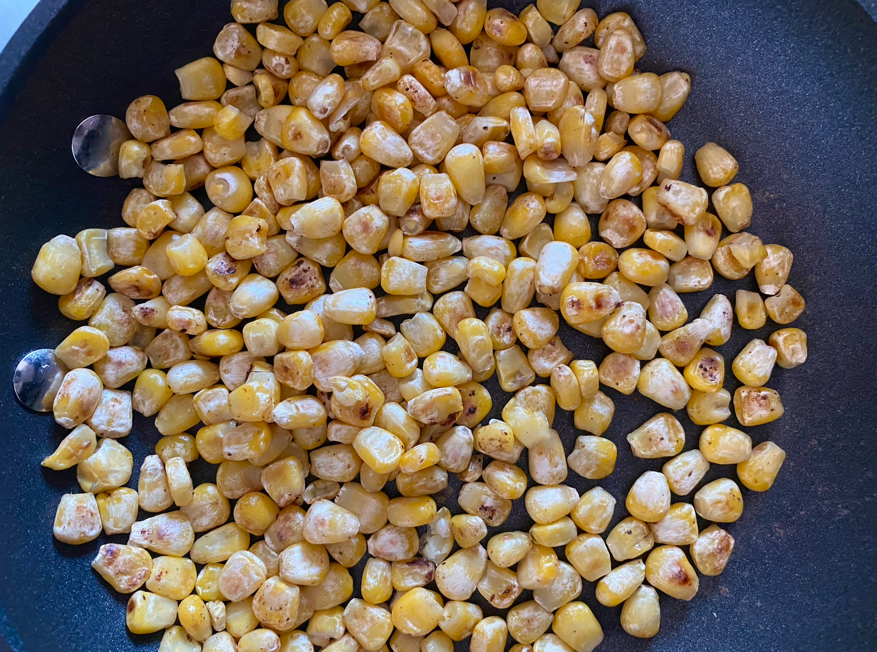 Corn dry-roasted, before food processing half of the kernels. (Photo: Allie Chanthorn Reinmann)