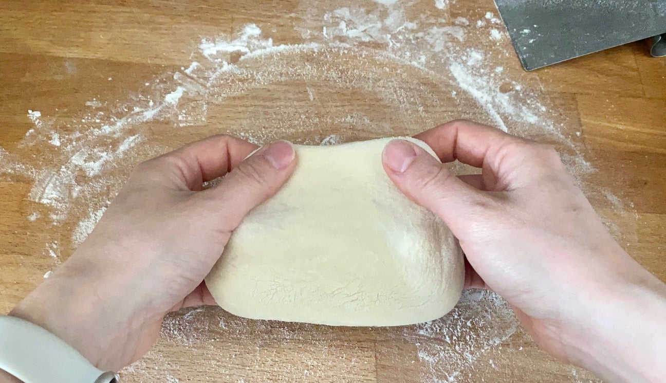 Stretching after the rest time when the dough is more elastic. (Photo: Allie Chanthorn Reinmann)