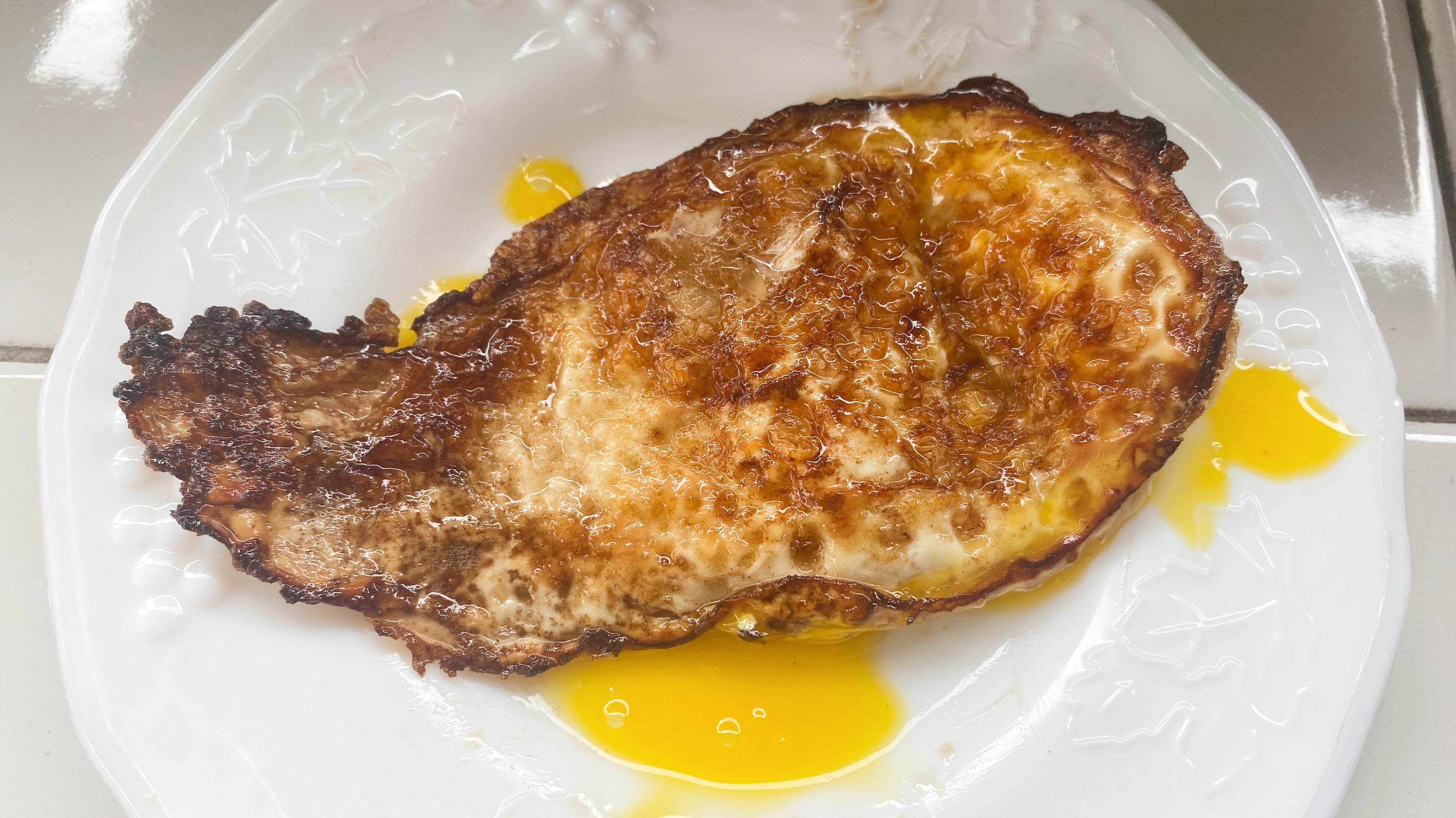 The bottom of an egg fried in butter. (Photo: Claire Lower)
