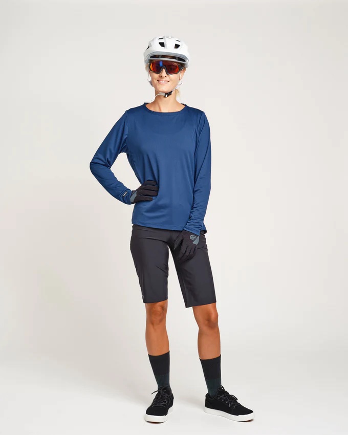 A person wearing a blue and black mountain biking cycling gear
